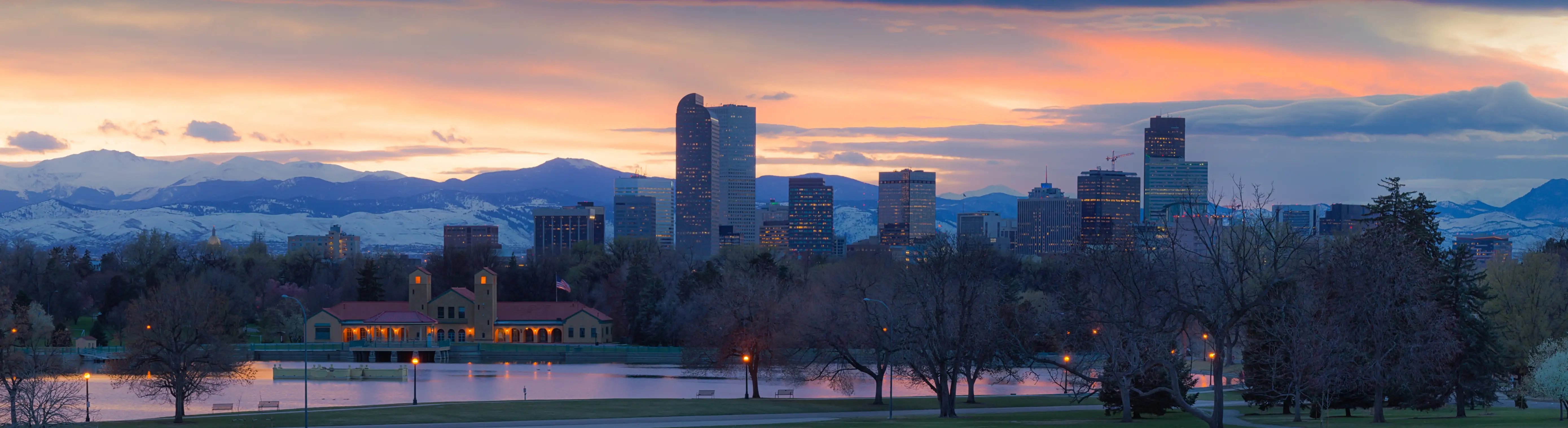 The Denver skyline at sunset, seen across City Park